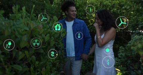 Romantic couple walking through sunlit shrub-lined garden holding hands with green energy HUD icons