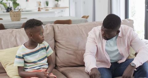 Father and Son Bonding on Cozy Living Room Sofa