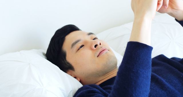 Young Man Lying in Bed Using Smartphone for Entertainment - Download Free Stock Images Pikwizard.com