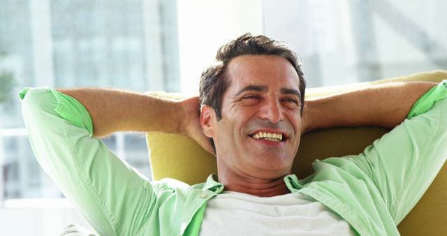 Smiling Mature Man Relaxing at Home in Bright Room - Download Free Stock Images Pikwizard.com