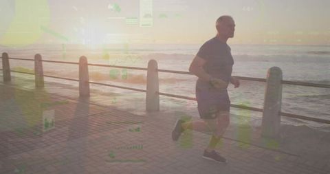 Senior man jogging on seaside promenade with green data overlay at sunset