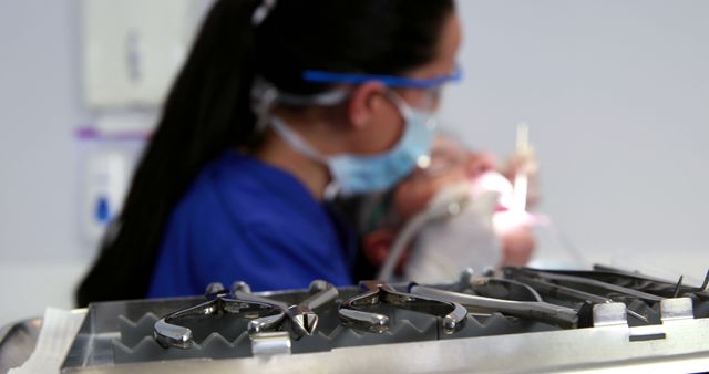 Dentist Working on Patient with Dental Instruments in Foreground - Download Free Stock Images Pikwizard.com