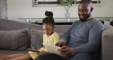 Father and Daughter Bonding, Exploring Tablets Together at Home