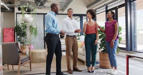 Colleagues celebrating successful business presentation