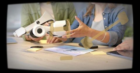 Office team examining vr headset prototype during collaborative product design meeting
