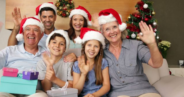 Happy Family Celebrating Christmas with Santa Hats and Gifts - Download Free Stock Images Pikwizard.com