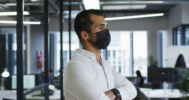 Male Professional Wearing Face Mask in Modern Office Environment - Download Free Stock Images Pikwizard.com