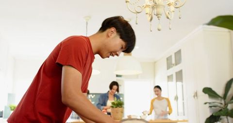 Diverse Family Cooking Together in Modern Bright Kitchen
