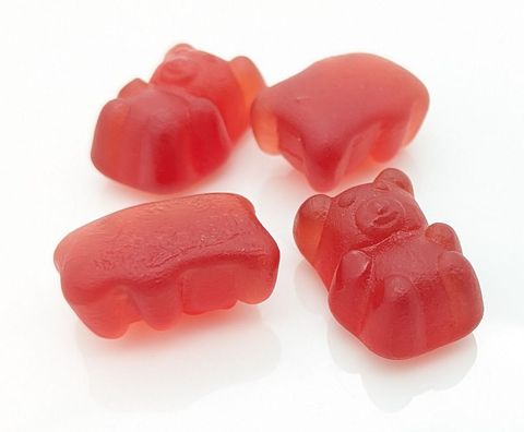 Red gummy bears on white background