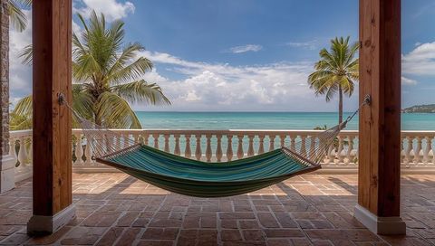Swaying hammock overlooking turquoise ocean on sunny tropical terrace