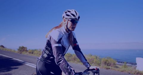 Woman Cycling on Coastal Road with Digital Overlay - Download Free Stock Images Pikwizard.com