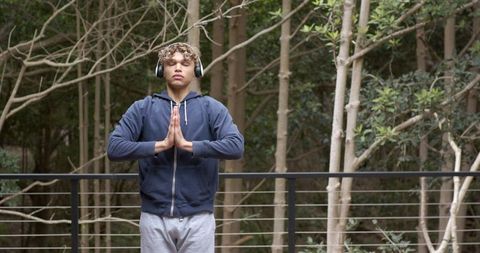 Man Practicing Meditation Outdoors with Headphones
