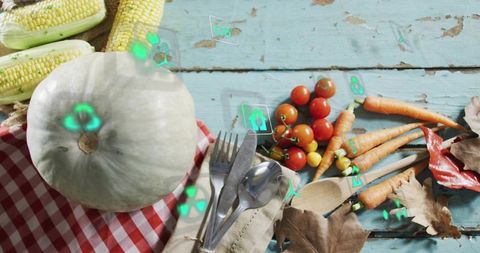 Pale green pumpkin harvest on turquoise table with corn, tomatoes, carrots and neon icons
