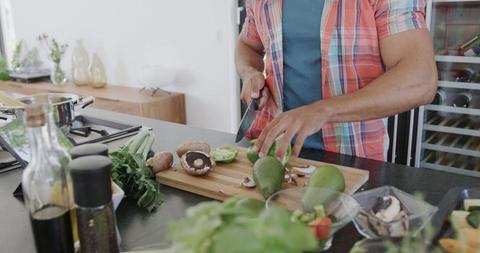 Man Chopping Fresh Vegetables for Meal Preparation at Modern Kitchen - Download Free Stock Images Pikwizard.com