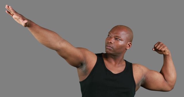 Strong African American Man Flexing Biceps and Pointing - Download Free Stock Images Pikwizard.com