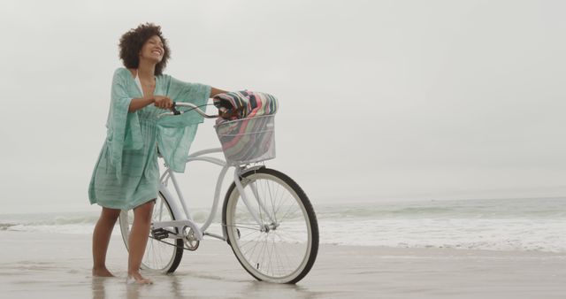 Joyful Young Woman Enjoying Bicycle Ride on Beach - Download Free Stock Images Pikwizard.com