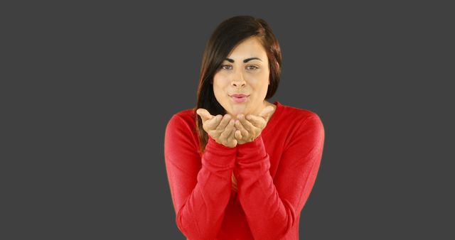 Woman Blowing Kiss in Studio with Red Sweater - Download Free Stock Images Pikwizard.com