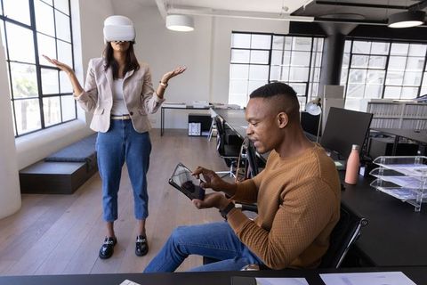 Modern Coworkers Exploring Virtual Reality in Trendy Office