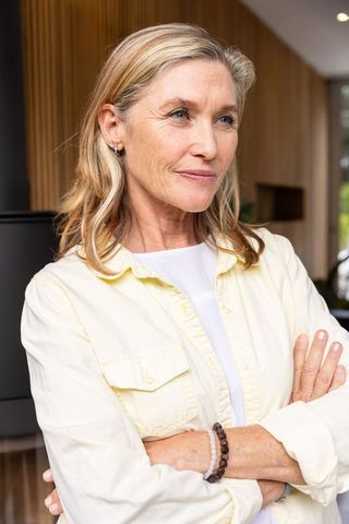 Confident Senior Woman Relaxing in Modern Minimalist Home