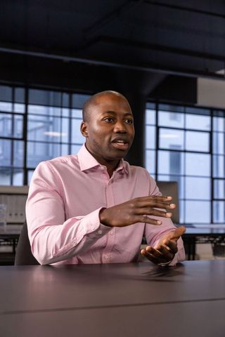 Professional African American Man Collaborating in Modern Office