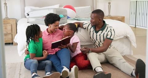 Family reading storybook and bonding in bedroom