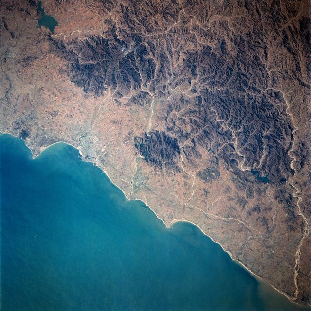 61A-39-052 (30 Oct-6 Nov 1985) --- This Earth view shows Quinhuangdao, China.  The Great Wall of China can be seen in this photograph.  The center coordinates are 40.0 north latitude and 120.0 east longitude.  This photograph was taken from an altitude of 180 miles, on the 24th orbit of the Space Shuttle Challenger.  The crew consists of astronauts Henry W. Hartsfield, Jr., commander; Steven R. Nagel, pilot; mission specialists James F. Buchli, Guion S. Bluford, Jr., Bonnie J. Dunbar; payload specialists Reinhard Furrer (DFVLR), Ernst Messerschmid (DFVLR), and Wubbo J. Ockels (ESA).