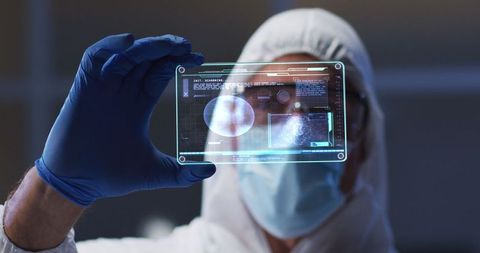 Scientist analyzing digital medical data on transparent screen