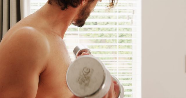 Man exercising with dumbbells at home 4k - Download Free Stock Photos Pikwizard.com