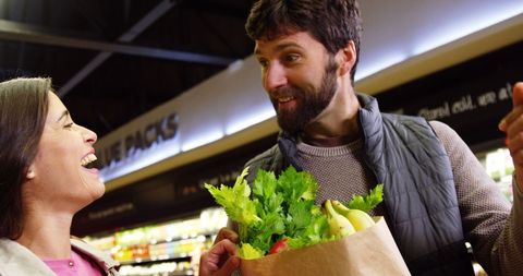 Joyful Couple Shopping for Organic Produce at Supermarket