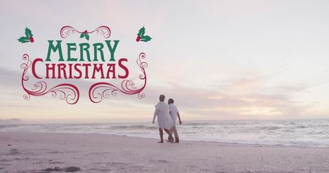 Senior Couple Walking on Beach with Christmas Greetings