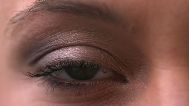 Close view of woman's eye slowly opening and closing. Demonstrates natural beauty and elegance through minimal makeup. Useful for beauty blogs, advertising eye cosmetics, or depicting human emotions in artistic or educational contexts.