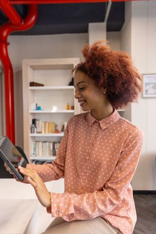 Female professional using tablet in open office environment