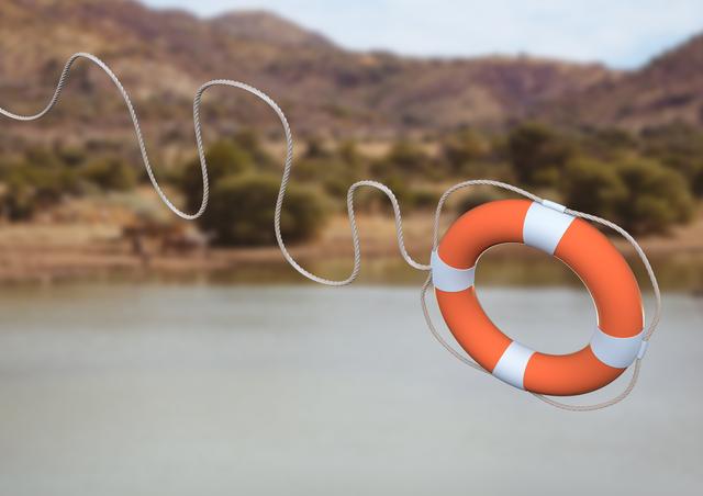 Digital composite image of lifebuoy with rope thrown in mid-air