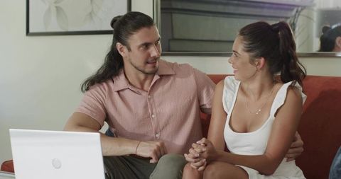 Couple Sitting on Sofa Holding Hands with Laptop, Cozy Modern Home Romance