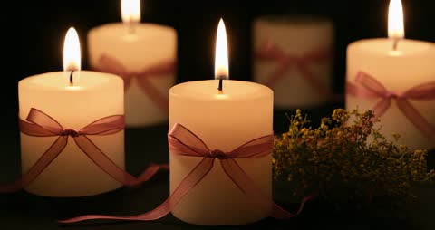 Lighting Ribboned Candles Creating Warm Ambiance with Flowers
