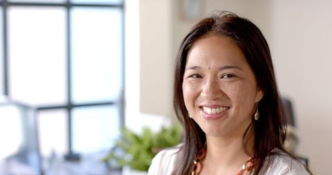 Smiling Professional Woman in Bright Office Setting