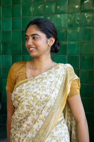 Elegant indian woman in profile wearing a floral sari