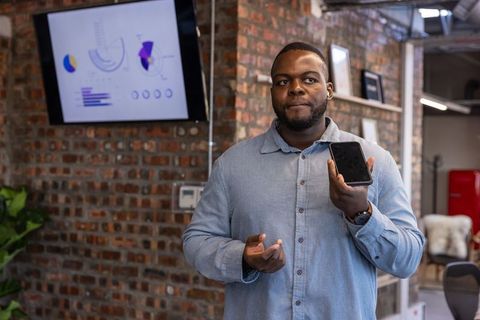 Confident Professional Presenting Analytics with Smartphone