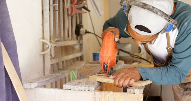 Carpenter Cutting Wood Using Electric Saw in Workshop - Download Free Stock Images Pikwizard.com