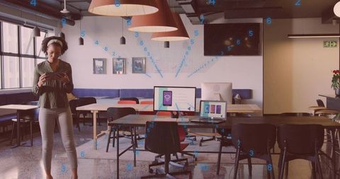 Woman in modern coworking space using smartphone