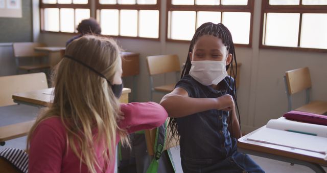 Diverse Schoolchildren Wearing Masks in Classroom Elbow Bumping - Download Free Stock Images Pikwizard.com