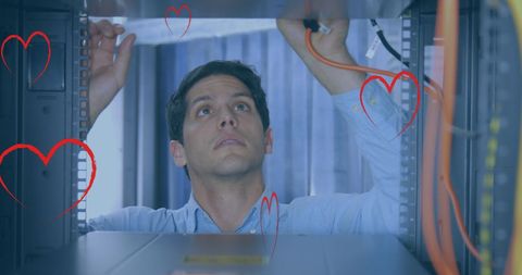 It technician organizing cables in network server room