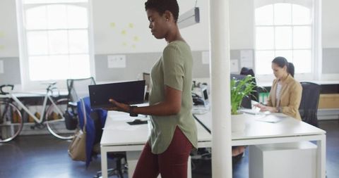 Focused African American Businesswoman Analyzing Documents in Office