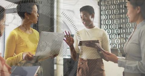 Diverse Professional Women Collaborate in Modern Office Environment