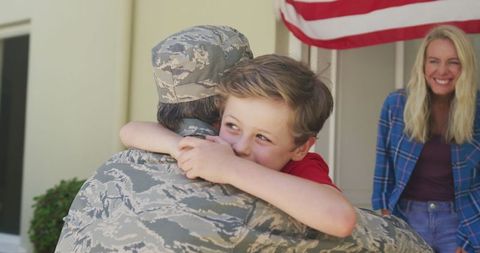 Soldier Father Reuniting with Son While Wife Smiles Nearby - Download Free Stock Images Pikwizard.com