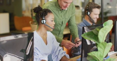 Diverse Team Collaborating with Headsets in Modern Office Space - Download Free Stock Images Pikwizard.com