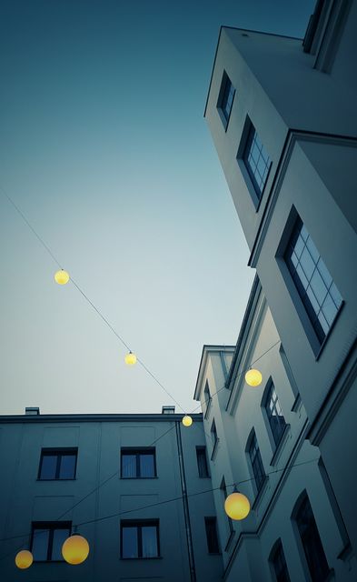 String Lights Across Modern Urban Building at Dusk - Download Free Stock Images Pikwizard.com