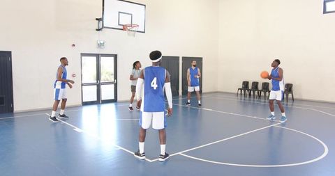 Basketball team practicing in indoor gymnasium