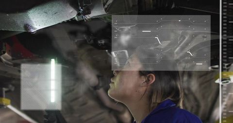 Female Technician Inspecting Vehicle Undercarriage with Augmented HUD Overlay and LED Light