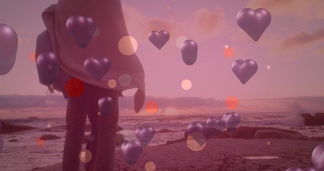 Person Standing by Ocean with Overlay of Hearts and Sunset Colors - Download Free Stock Images Pikwizard.com